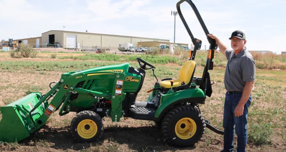 Neil Motley beside a 1023E compact utility tractor.